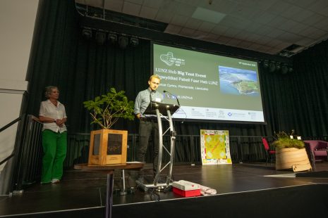 Alan Radbourne reading Harriet's poem. Harriet standing to the side of him