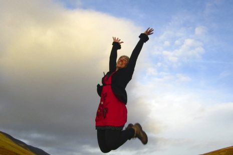 Harriet Fraser from "somewhere nowehere" jumping in the air with joy in the Lake District